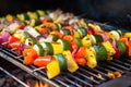 skewered vegetable kabobs roasting on rotisserie grill Royalty Free Stock Photo