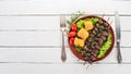 Skewers of chicken hearts, corn and fresh vegetables. On a wooden background. Top view. Royalty Free Stock Photo