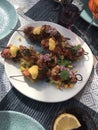 Skewers of grilled chicken thighs with sweet potatoes, corn, huancaina sauce cream and chalaca Royalty Free Stock Photo