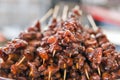 Skewers of meat pieces in sweet and sour sauce closeup Royalty Free Stock Photo