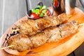 Skewers of Meat with sauce and potatoes fries in a bucket on wooden cutting board Royalty Free Stock Photo