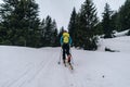 Ski alpinist training in the snowy Austrian Alps with equipment during the daytime