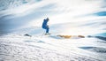 Ski athlete performing acrobatic jump on downhill at sunset - Adult skier riding down for winter time in ski slope - Extreme snow Royalty Free Stock Photo