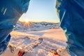 Ski athlete standing in front of wonderful sunset on top of the mountain - Legs view of young skier with sun back light - Sport