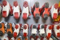 Ski boots of various colors installed in a row with the soles up in the rental of ski equipment. Sports Royalty Free Stock Photo