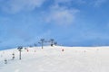 Ski chair lift  in France, with blue sky and few clouds - copy space above Royalty Free Stock Photo