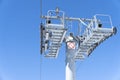 Ski chair lift over blue sky. Ski lift empty ropeway on hilghland mountain winter. Ski chairlift cable way with people enjoy Royalty Free Stock Photo