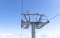 Ski chair lift over blue sky. Ski lift empty ropeway on hilghland mountain winter. Ski chairlift cable way with people enjoy Royalty Free Stock Photo