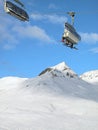Ski chair-lift with skiers. Switzerland. Royalty Free Stock Photo