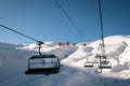 Ski chair lift and skiing slopes in Alps Royalty Free Stock Photo