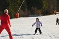 Ski coach giving a lesson to a child