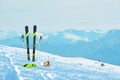 Ski equipment in the snow. Ski slope and mountain peaks is in the background Royalty Free Stock Photo
