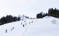 Ski field large white snow on slopes. Ski slopes snow. Winter banner panorama of slope at ski resort, people skiing, Royalty Free Stock Photo