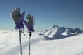 Ski gloves on poles on the background of southern slope Aibga Ridge of Western Caucasus at Rosa Khutor Alpine Resort