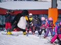 Ski instructor in penguin suit studies children. Alps, Austria, Zams on 22 Feb 2015