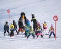 Ski instructor in penguin suit studies children. Ski resort in A