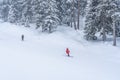 Ski instructor and skier in the french ski resort on mountain, skiing in heavy snow. Royalty Free Stock Photo