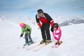 Ski instructor teaching children skiing