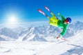 Ski jump. Young man skiing in winter mountains