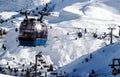 Ski lift in the Alps with many skiers on the way