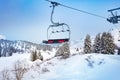 Ski lift chair on Alpine resort over fir forest