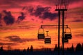 ski lift chairs silhouetted against a vibrant sunset sky