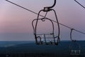 Ski lift chairs on twilight