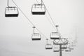 Ski lift in clouds. Chairlift  in Swiss alps in Switzerland Jungfrauregion Royalty Free Stock Photo