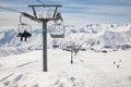 Ski lift empty ropeway on hilghland alpine mountain winter resort on bright sunny day. Royalty Free Stock Photo