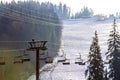 Ski lift with empty seats over the snow mountain in ski resort Royalty Free Stock Photo