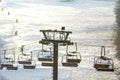 Ski lift with empty seats over the snow mountain in ski resort Royalty Free Stock Photo