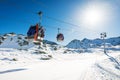 ski lift gondolas against blue sky over slope at ski resort