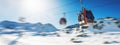 ski lift gondolas against blue sky over snowy mountains at ski resort at Italy Alps on sunny winter day. copy space