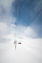 ski lift high in the clouds against the backdrop of snow-capped mountains