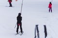 A ski lift pulls a person uphill skiing and snow