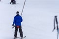 A ski lift pulls a person uphill skiing and snow