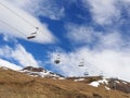 A ski lift in a ski resort in the Pyrenees on a slope with little snow