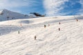 Ski lift ropeway on hilghland alpine mountain winter resort on bright sunny day. Ski chairlift cable way with people enjoy skiing Royalty Free Stock Photo