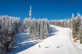 Ski lift with seats going over the mountain over ski tracks Royalty Free Stock Photo