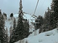 Ski lift, ski slopes and snow-capped mountains in Hoch-Ybrig, Switzerland.