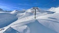 Ski lift and ski slopes in beautiful snowy mountains