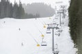 Ski lift and slopes during foggy weather in Bansko