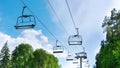 Ski lift in the summer. Chair lift with empty cabins on a sunny summer day against the blue sky Royalty Free Stock Photo