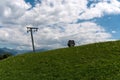 Ski lift in a summertime meadow with a cable railway cabin next to it Royalty Free Stock Photo