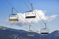 ski lifts against the background of a blue sky with clouds. Ski resort Royalty Free Stock Photo