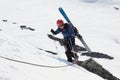 Ski mountaineer climb on rope on rocks