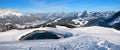 Ski piste with accumulation lake and view to Wilder Kaiser mountains