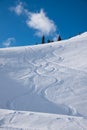 Ski piste with deep powder snow and tracks from skiing or snowboard Royalty Free Stock Photo