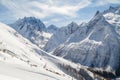 Ski piste, a small chair ski-lift against the backdrop of the Caucasus Mountains range near the town of Dombai, Russia Royalty Free Stock Photo