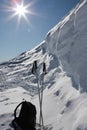 Ski poles and rucksack on snow